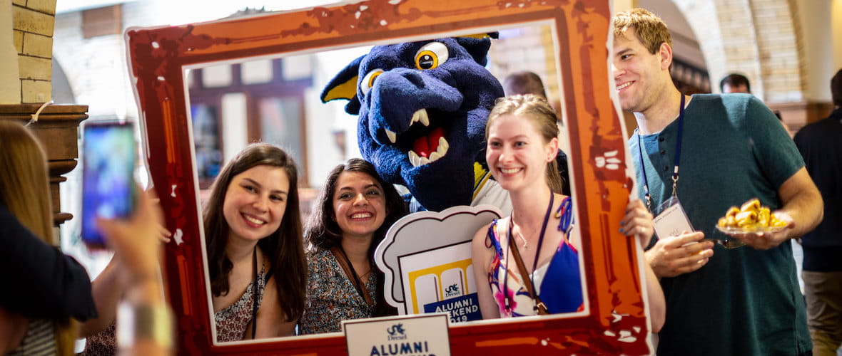 Group of Drexel alumni with Mario the draogn mascot