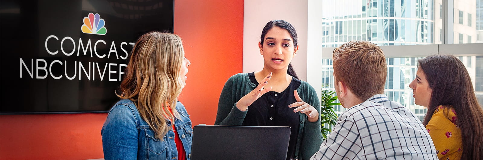 Group of students having a discussion in a Comcast conference room