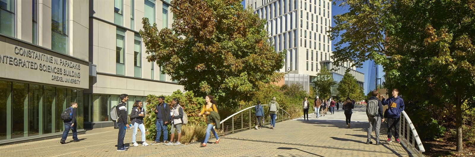 Students walking across footbridge on campus