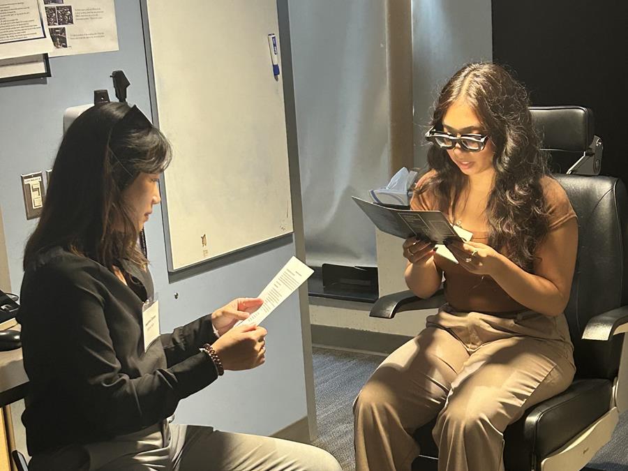 Optometry students conducting eye exam