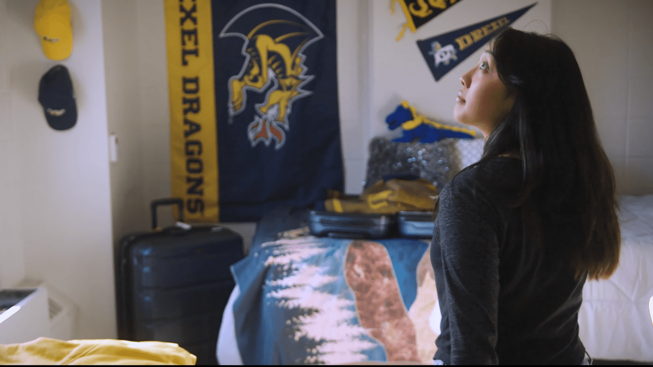 female student in Drexel dorm room)
