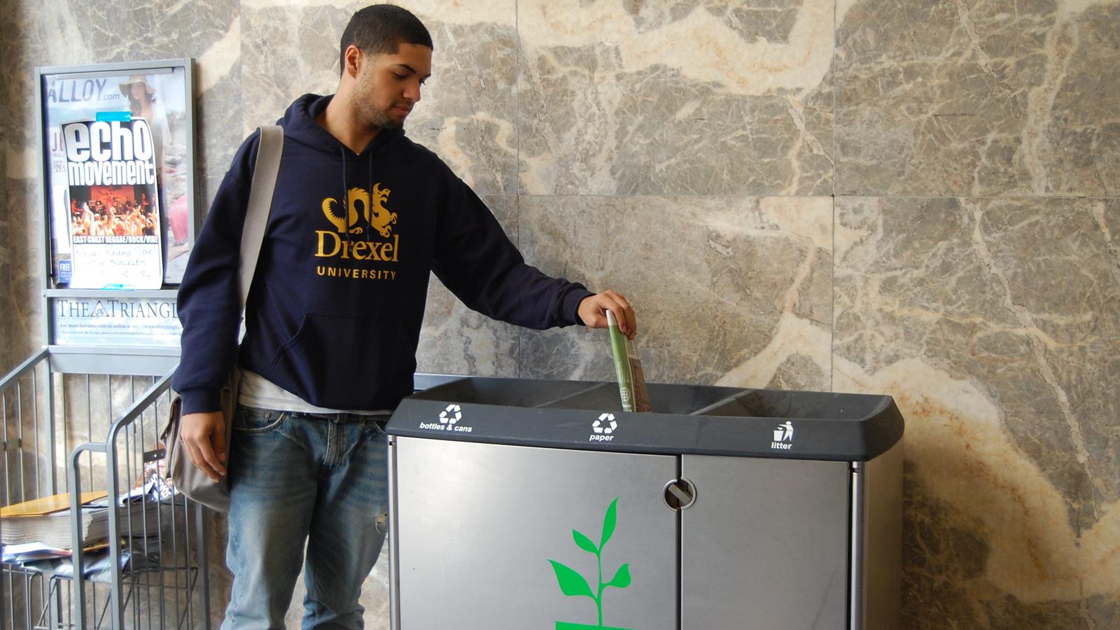 Drexel student using recycling bin