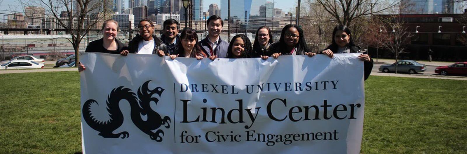 Group Photo holding the lindy center banner