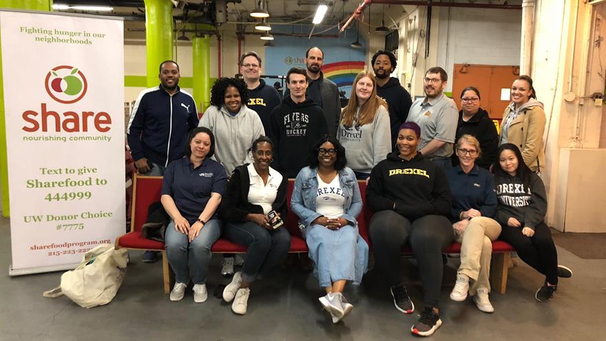 Staff group photo with share program banner
