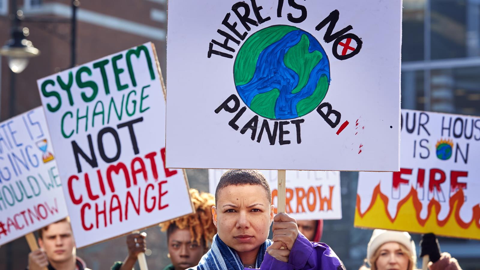 people holding posters at a climate march