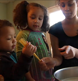 Barbie Izquierdo and her two children cooking at home, as seen in A Place at the Table