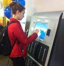 A Drexel student signs out a MacBook for use