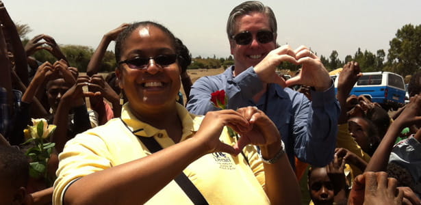 Drexel President John A. Fry with Dr. Shannon Marquez, director of Global Health Initiatives at Drexel, visit with children at Ethiopia's Kechema village.