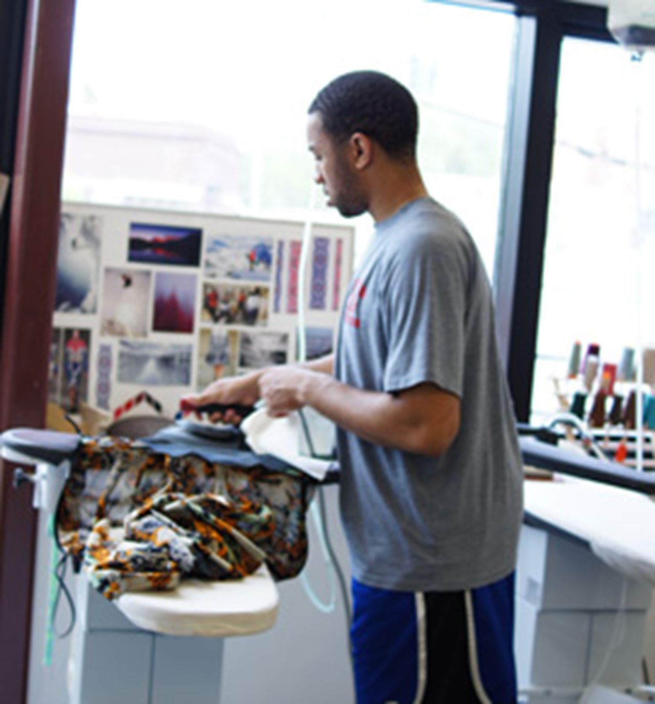 Devon Akrdige steam presses his garments. Photo credit: Neelam Chandwani.