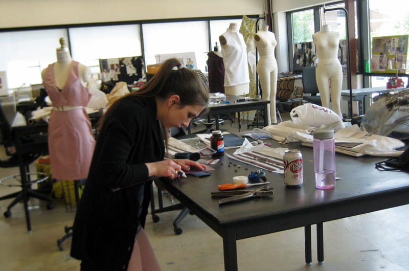 Rebekah Quasny puts the finishing touches on her collection to be shown at the annual senior fashion show.