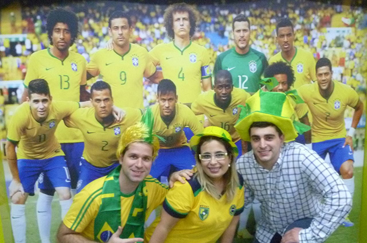 Posing with soccer team poster