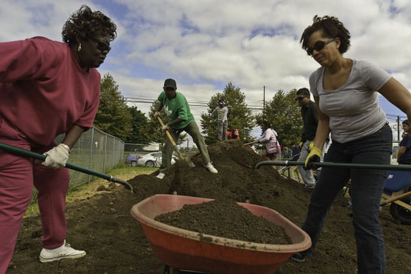 Community members help build the garden.