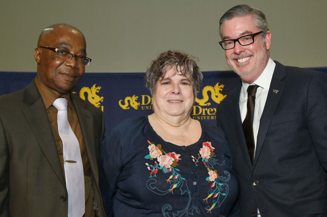 Miriam Kotzin, at center, with Drexel President John Fry, right, and Abisoeh Porter, PhD, left, head of the Department of English & Philosophy.