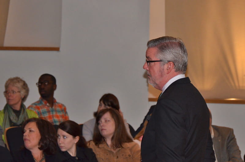Fry listens as a member of the audience asks a question during Wednesday's town hall.
