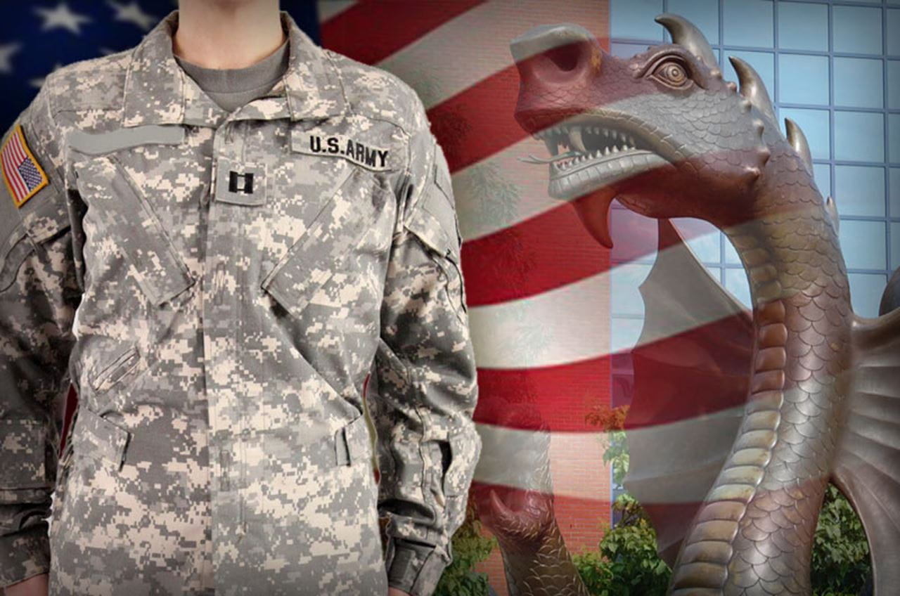 A soldier, flag and the Mario the Magnificent statue.