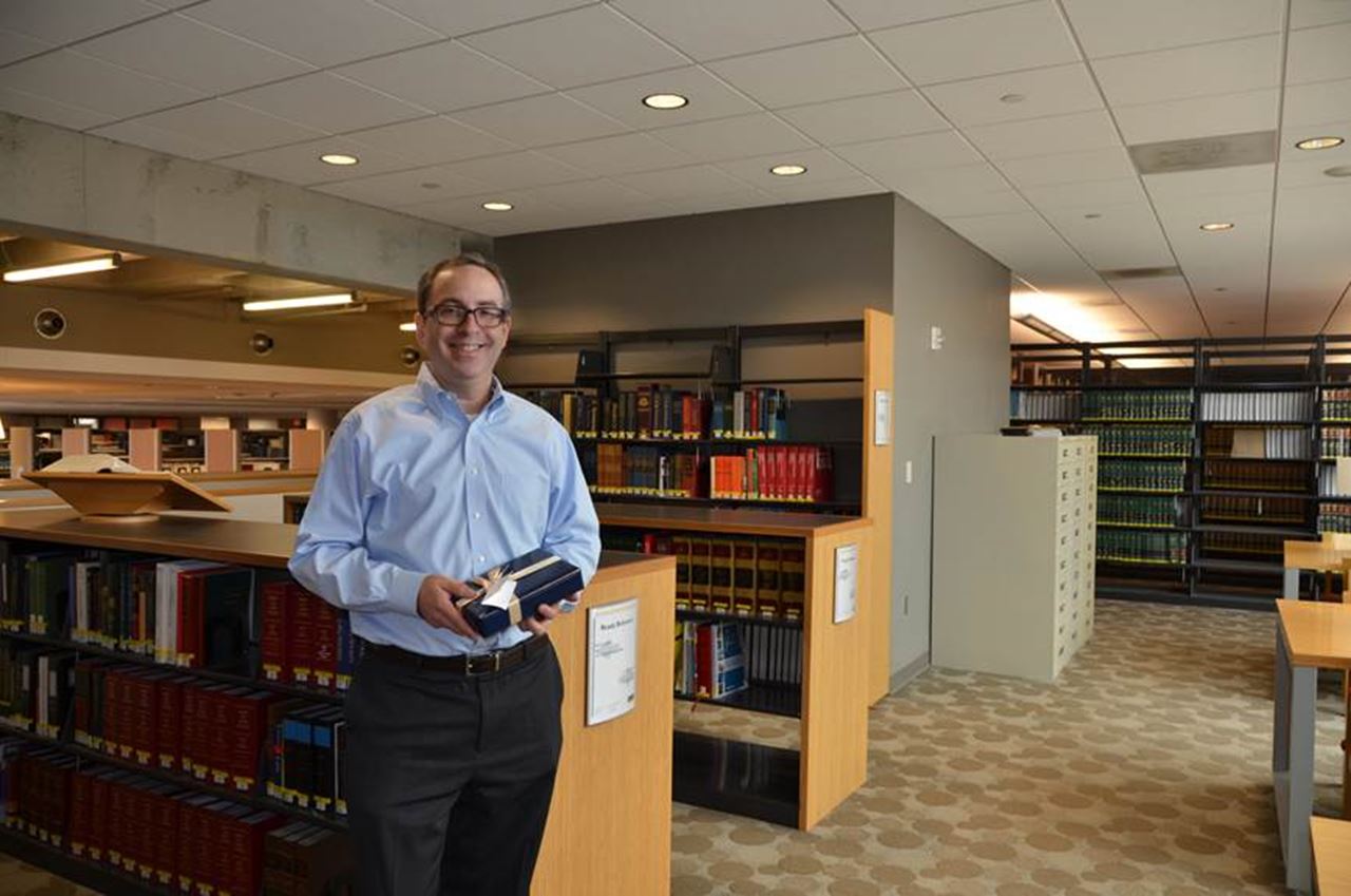 Daniel M. Filler, JD, senior associate dean for Academic and Faculty Affairs in the Kline School of Law, holding the iPad he won as a part of a drawing for taking part in the 2014-15 Why I Give campaign.