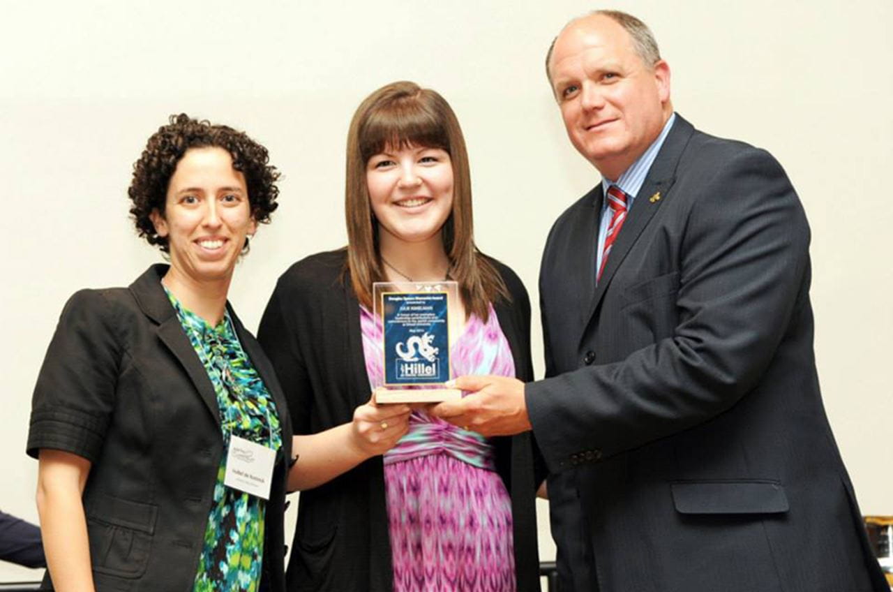 Drexel Dean of Students David Ruth, right, and Campus Rabbi for Hillel Isabel de Koninck, left, giving Julie Kimelman the Douglas Spears Memorial Award in 2014.