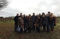 The MGMT 370 course poses in their client's vineyard in France.
