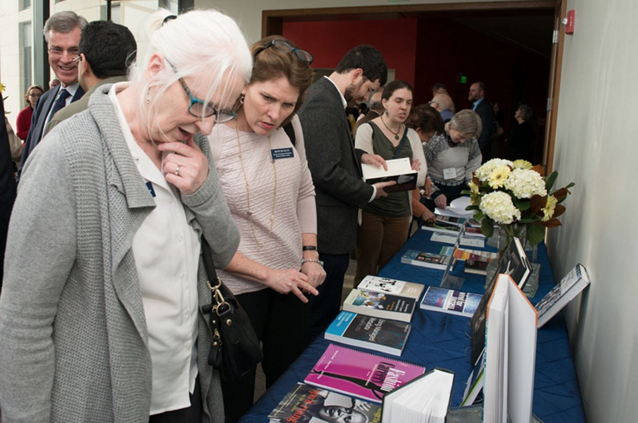 Checking out the books authored and edited by Drexel faculty and staff. By Jaci Downs Photography.