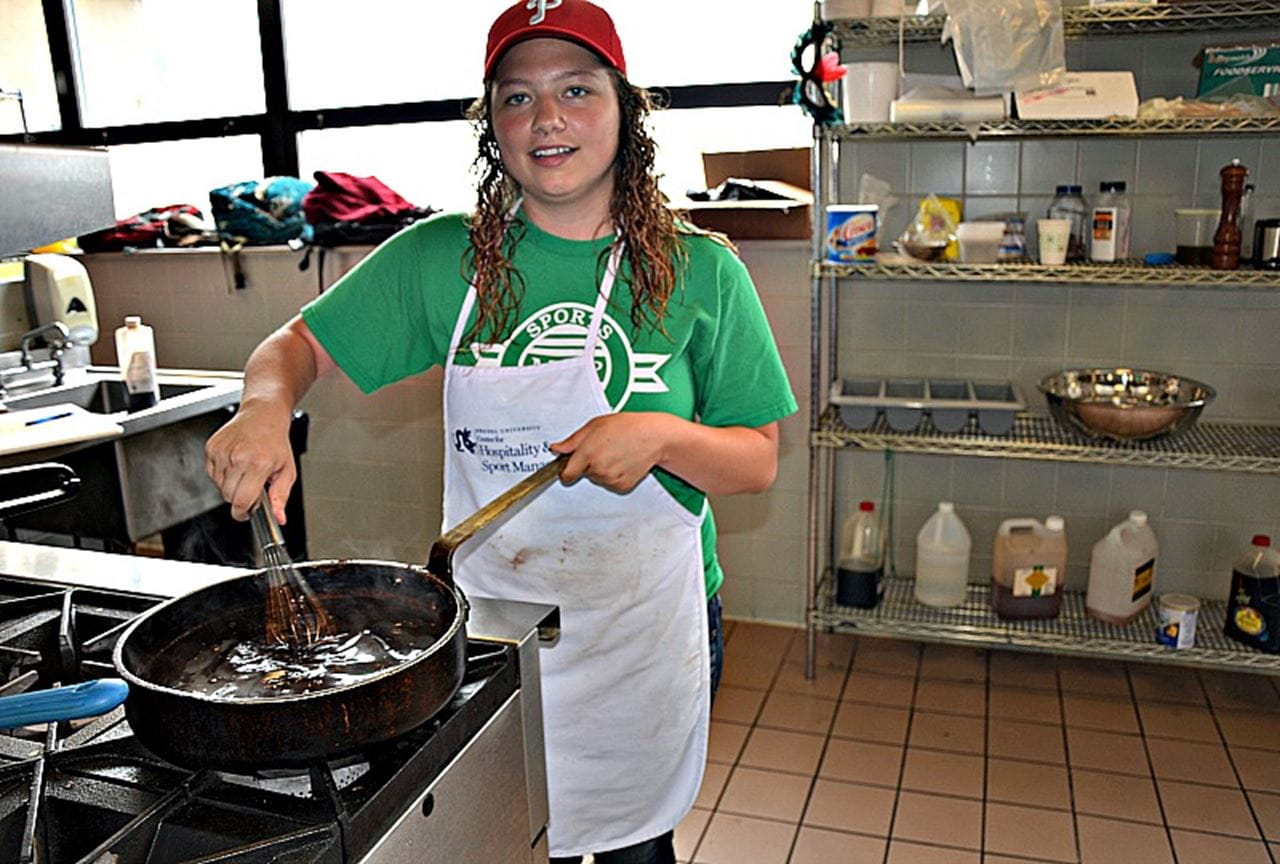 Melissa Trofa, a sophomore finance and business analytics major, prepares the choclate molé glaze for the "Chocolat" class.