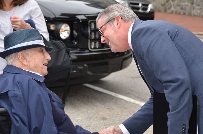 Raymond G. Perelman, left, shaking hands with Drexel President John A. Fry, right, before the groundbreaking ceremony.