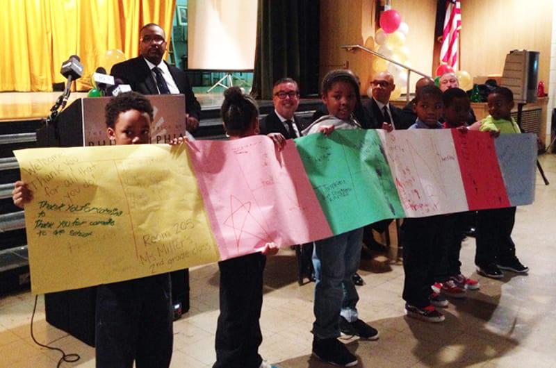 McMichael Students holding up posters as a thank you for Promise Neighborhood grant