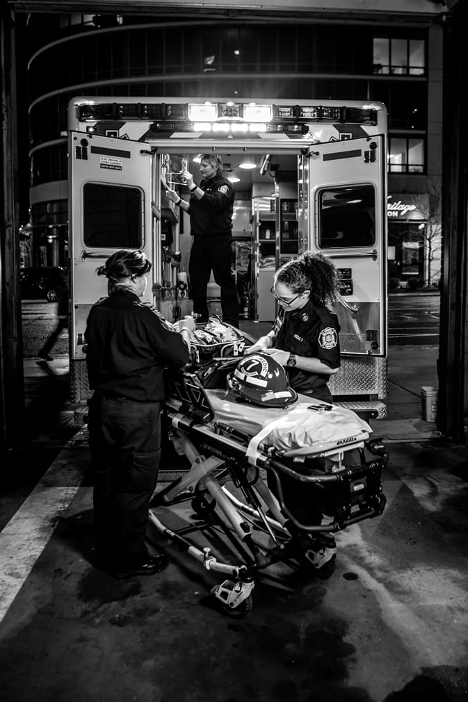 Ambulance crew getting a gurney ready for a call. Photo by Jeff Fusco.