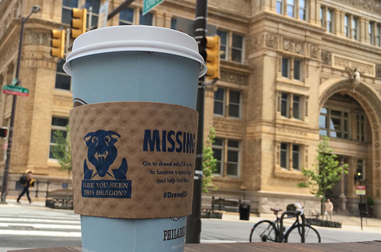 One of the "Have you seen this dragon?" coffee sleeves being distributed as part of the Day of Giving.