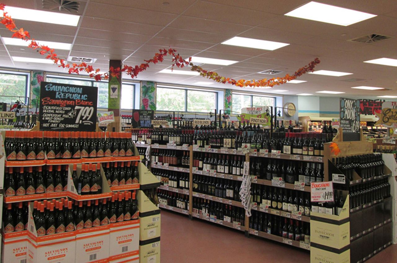 Wine on shelves at a grocery store.