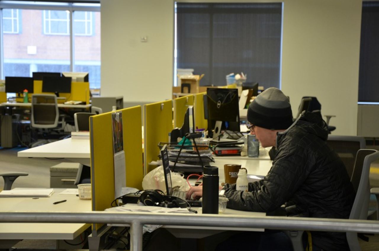 A student works at one of the workstations set up in the space. 
