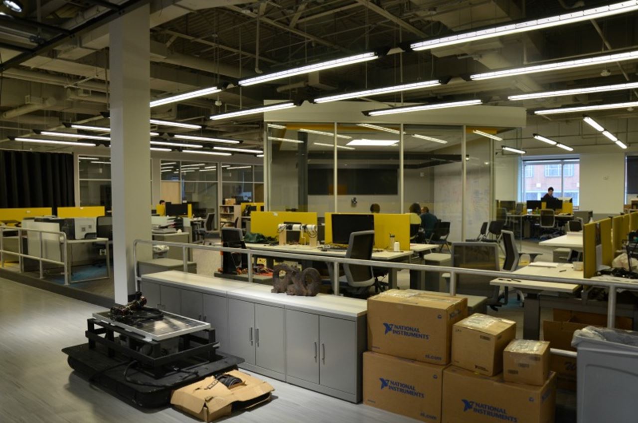 The heart of the workspace features student workstations surrounding a conference room, with the professor’s offices on the exterior. 