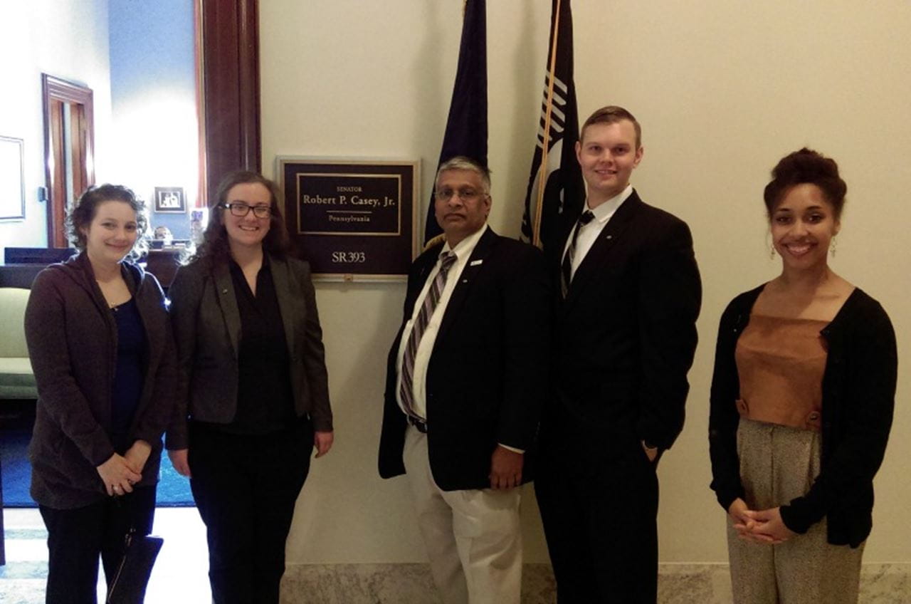 Drexel professor Ramesh Raghupathi, PhD, center, and doctoral student Brielle Ferguson, right, at the Society for Neuroscience's Capitol Hill Day.