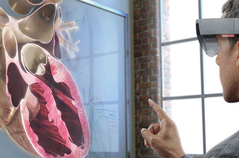 Image of student using app with hololens heart