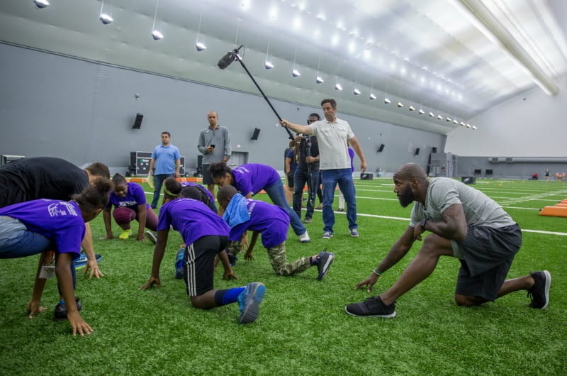 Eagles safety Malcolm Jenkins stretches with the Young Dragons.