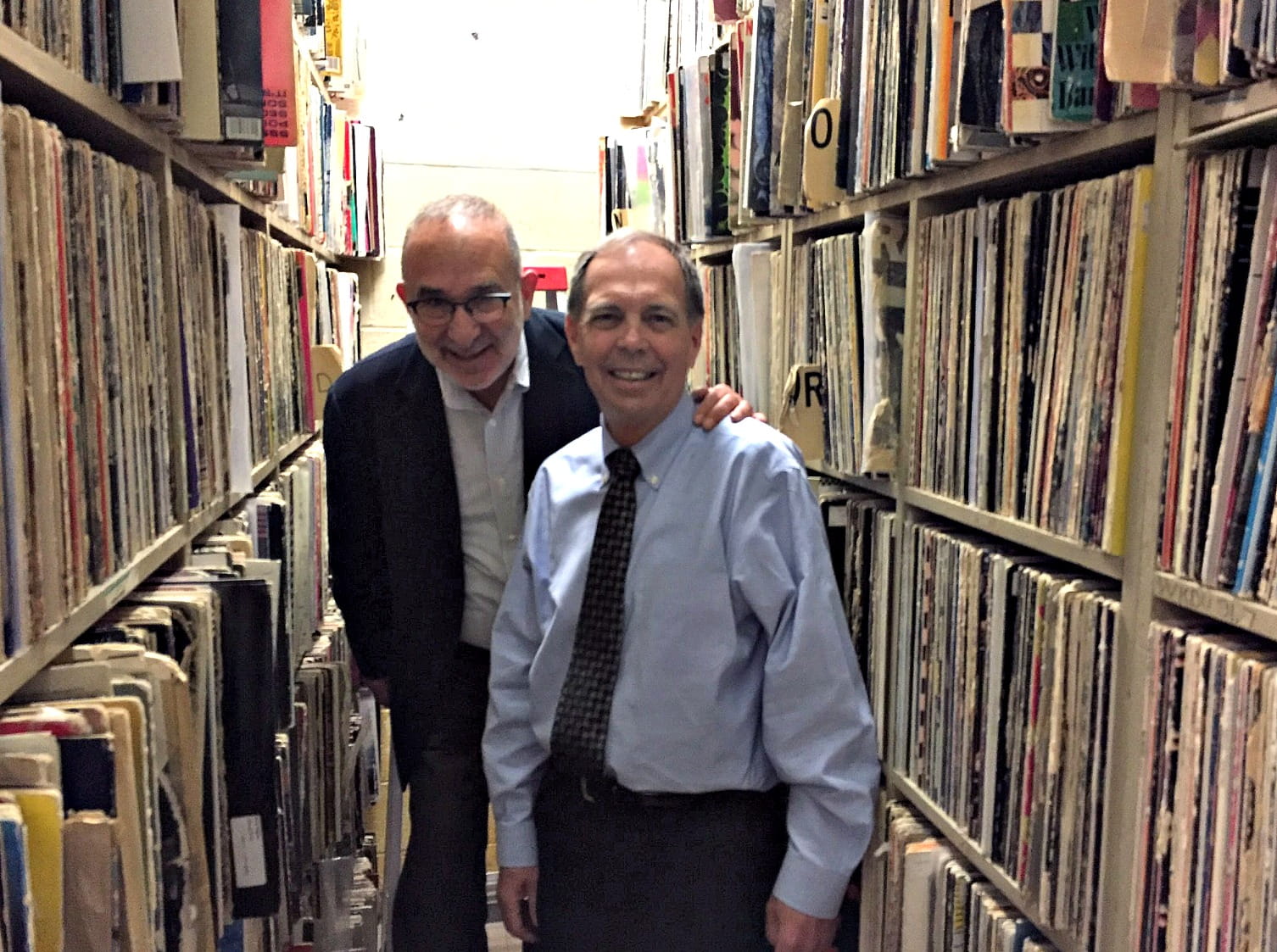 Dean Allen Sabinson, left, with Dean Frank Linnehan, right, in WKDU's vast vinyl archive. Photo credit Chris Burrell/WKDU.