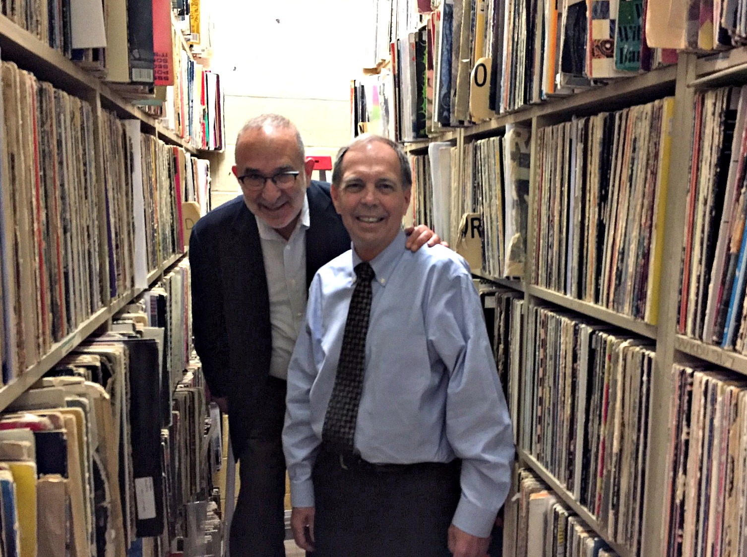 Dean Allen Sabinson, left, with Dean Frank Linnehan, right, in WKDU's vast vinyl archive. Photo credit Chris Burrell/WKDU.