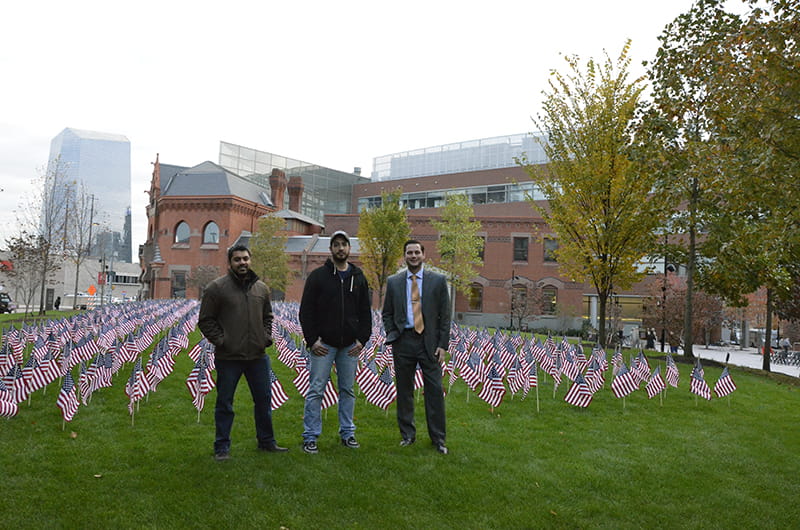 Drexel student veterans Joy Panicker Jr., Peter Majerick IV and Emery Mako (from left to right) stand in front of the flag installation.