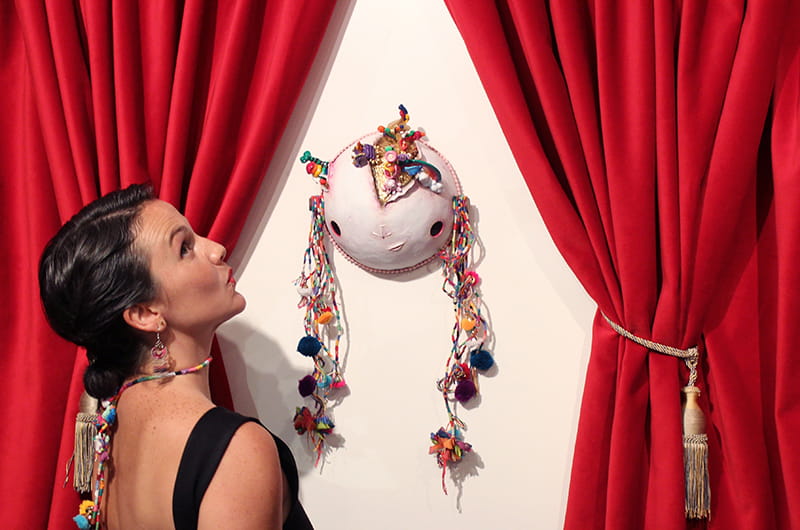 Barbara Carreño poses with "METU," the god she created to represent self-love, self-respect and self-forgiveness, at the exhibit.