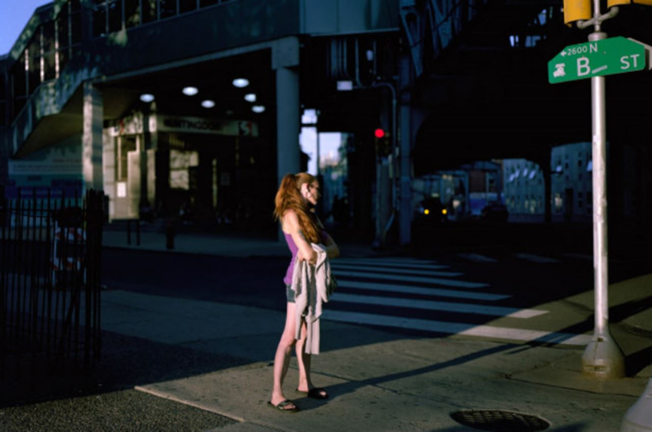 A woman stands on Kensington Ave. in one of photographer Jeffrey Stockbridge's portraits of a community struggling through the opioid epidemic. Stockbridge's work can be found at kensingtonblues.com.