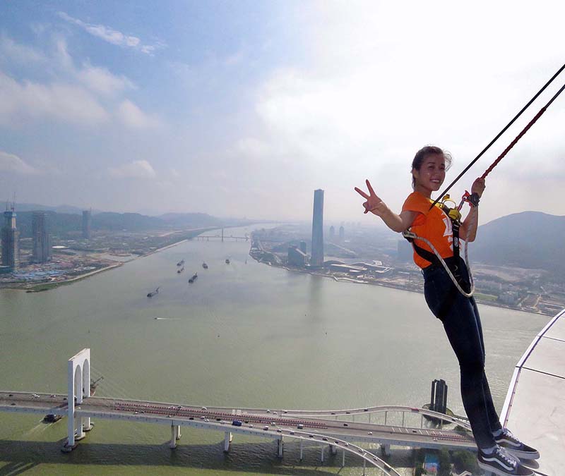 Kathy Chen balances on the edge of the Macau Tower, an intimidating 233 meters above ground. 
