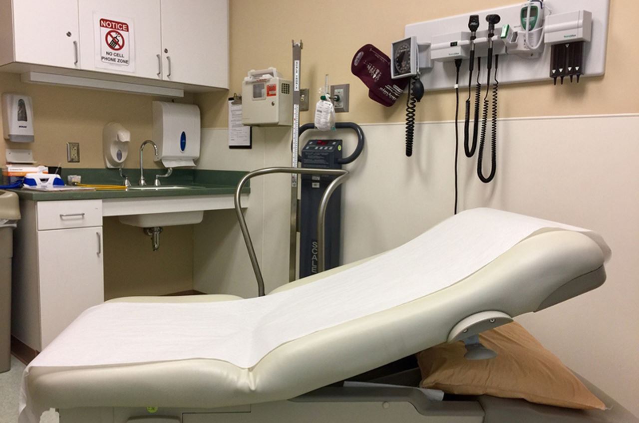 View of an empty doctor's office and exam table.