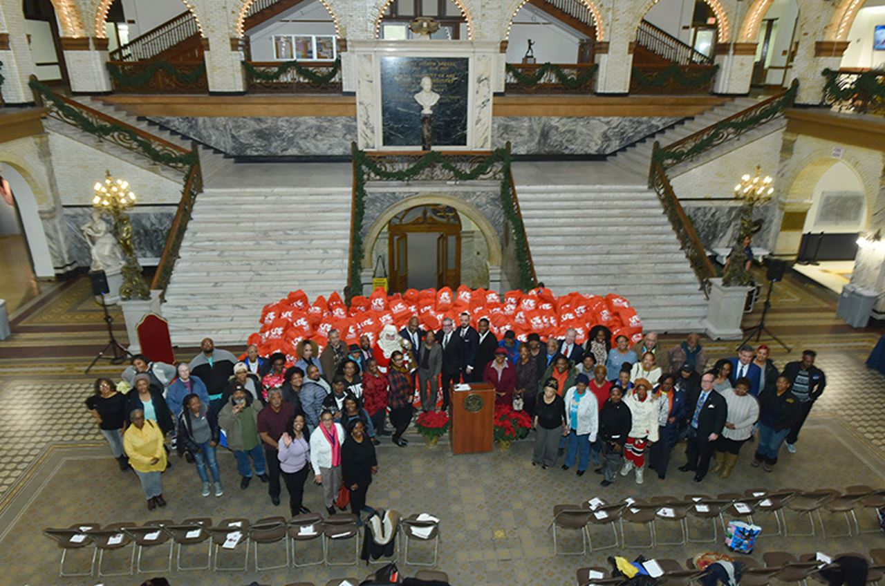 Drexel faculty and staff posed with members from community organizations at the Holiday Toy Drive's ceremony on Dec. 19. 