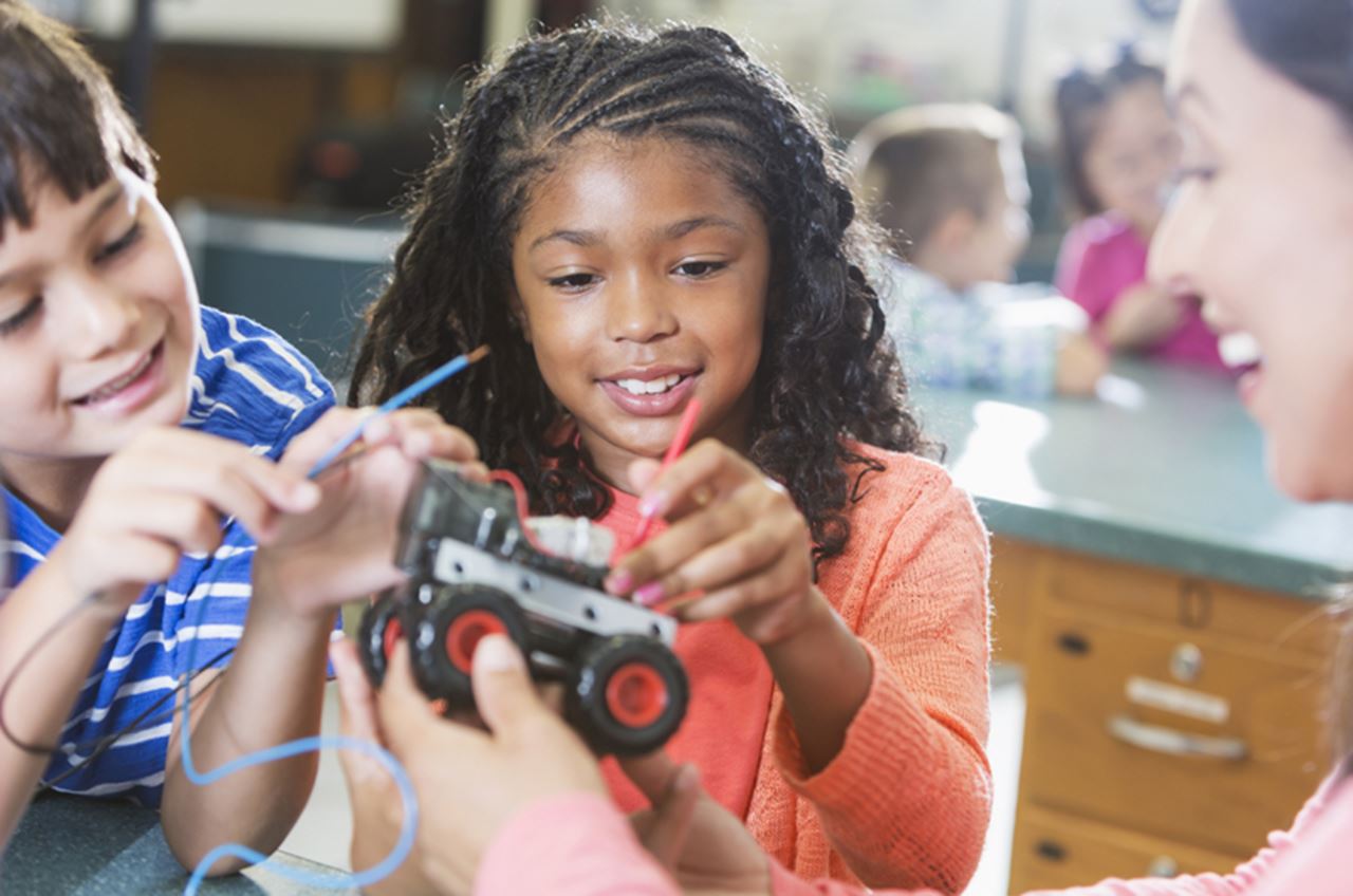 Photo of a boy and a girl working on a science project