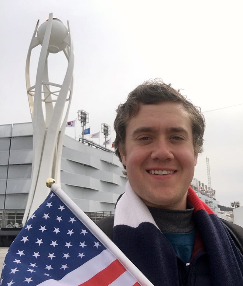 Ryan Roe and a statue of the Olympic flame in Pyeongchang.