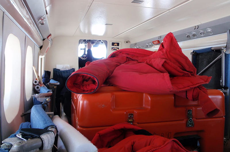 The inner cabin of a plane piled high with equipment