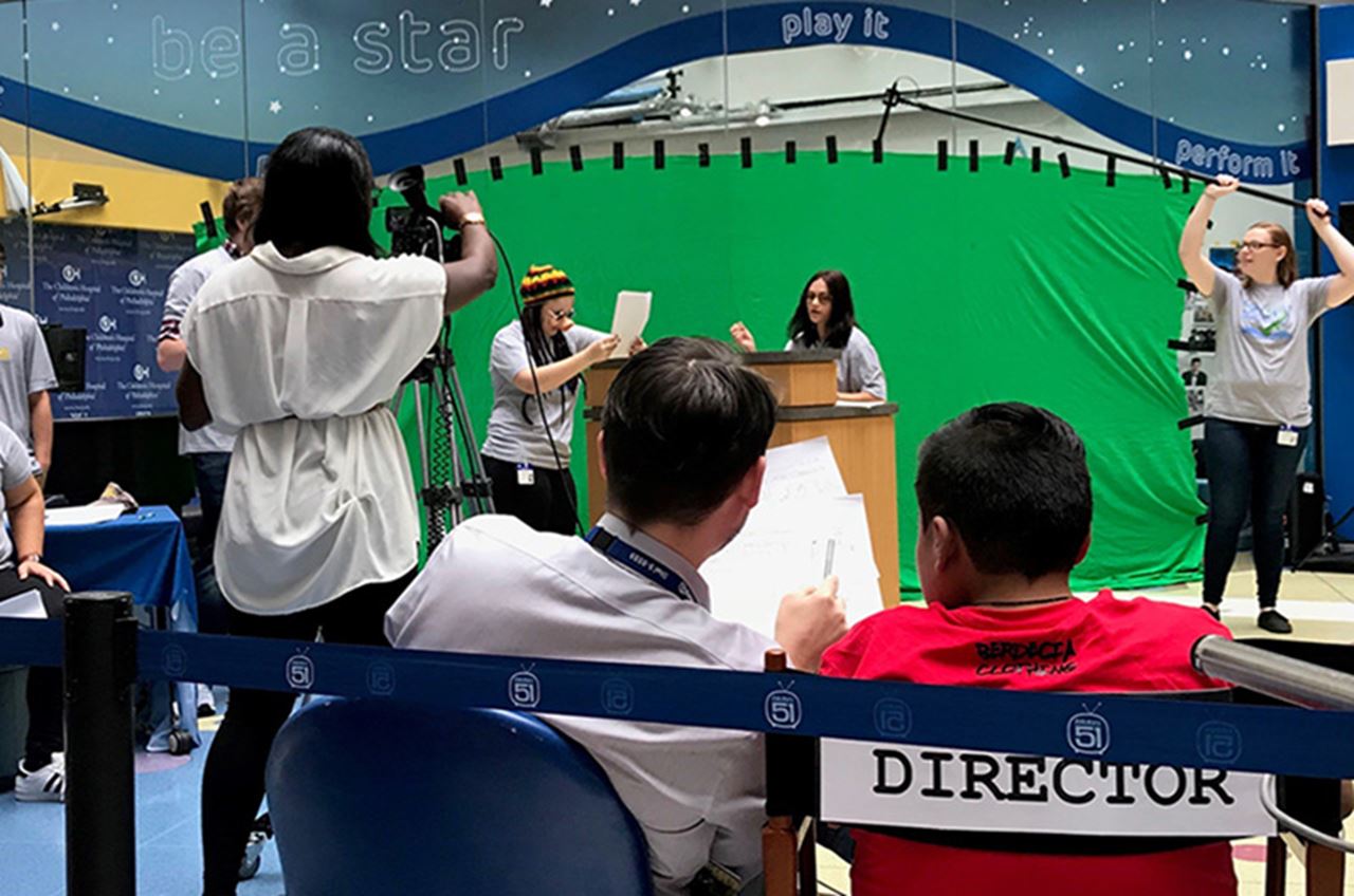 Jose sitting in the director's chair while Drexel students act out his "Dog Jackson's Dream" video.