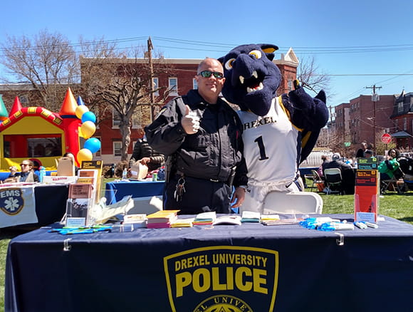 Officer Tom Cirone with Drexel's mascot, Mario the Magnificent.