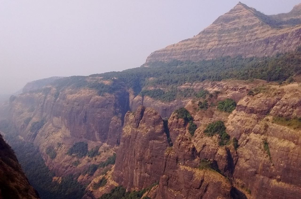 Layered lava flows from the Bushe and Poladpur Formations near the village of Tail Baila. Image credit, Courtney Sprain.