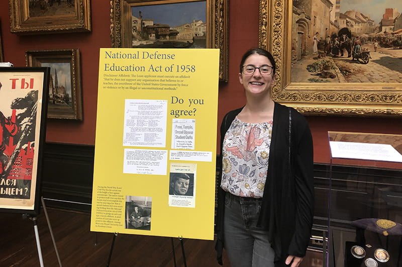 Egla Gjergo and her poster on the National Defense Education Act of 1958.