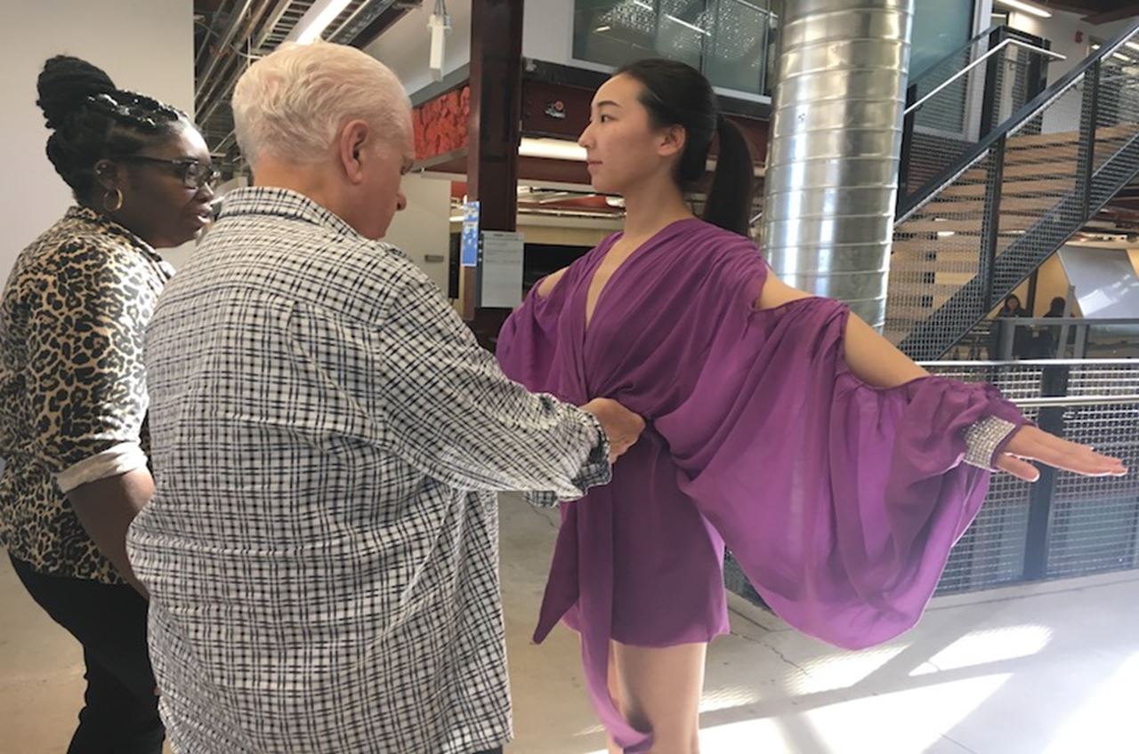 Critic Frank Agostino, student designer Chandricka Carr and student-model Ren (Joy) Fangyuan in a dress inspired by James Galanos.